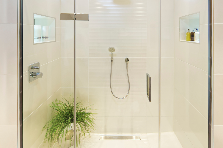 Frameless glass shower door enclosure with clean tile: identifying your door type is the first step