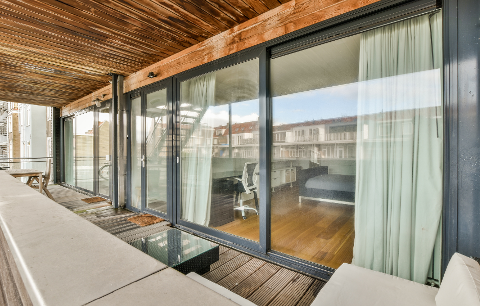 Modern sliding glass door with ocean view, finding the right replacement rollers for your door model