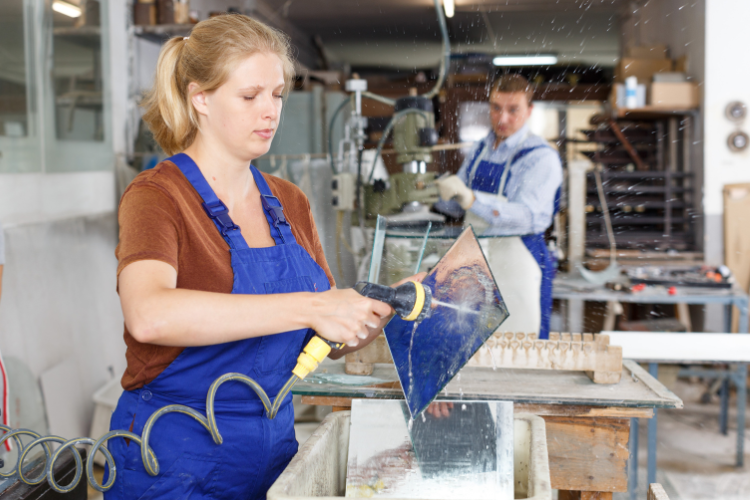 Professional cutting glass in a workshop: tempered glass must be cut before the tempering process