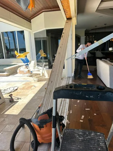 JDM technician cleaning up after a sliding glass door job at a Florida home