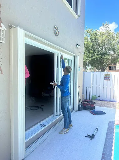 JDM technician installing a new sliding glass door at a Florida home