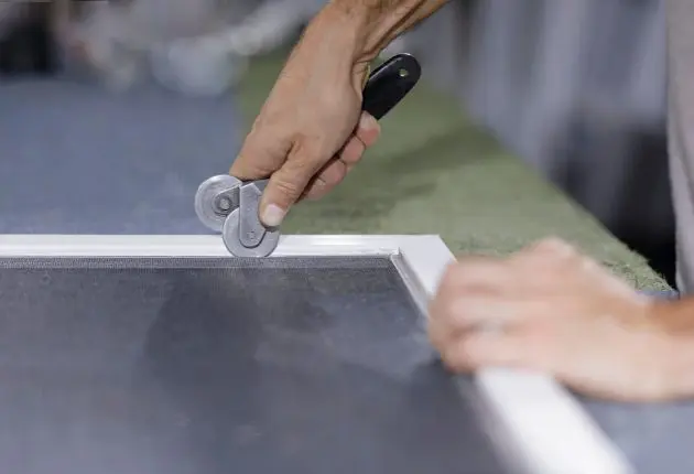 JDM technician performing screen door repair