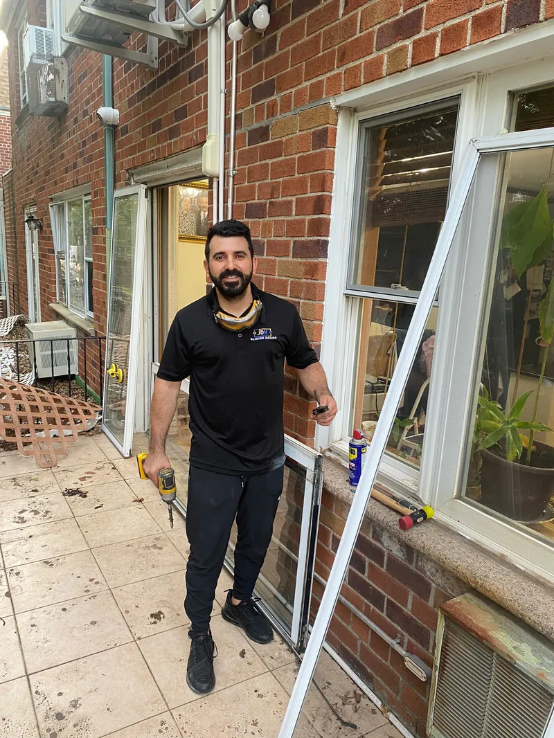 JDM technician repairing a sliding glass door in Fulton County